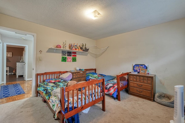 carpeted bedroom with a textured ceiling