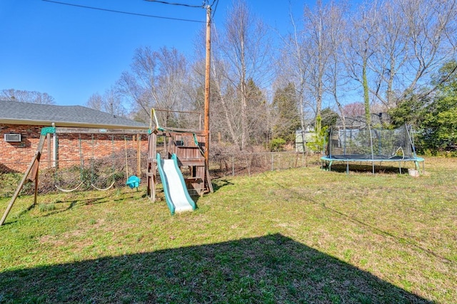 view of yard with a trampoline, a playground, and fence