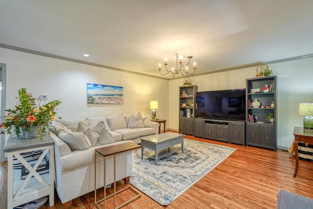 living room with hardwood / wood-style floors, a notable chandelier, and crown molding