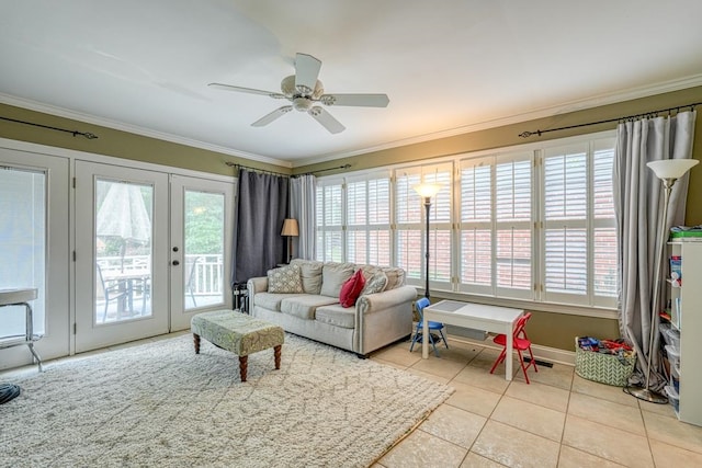 tiled living room with ceiling fan, crown molding, and french doors