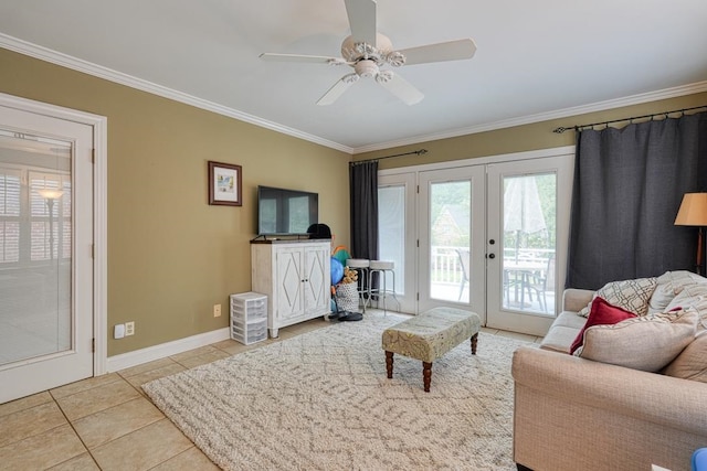 tiled living room featuring ceiling fan, crown molding, and french doors