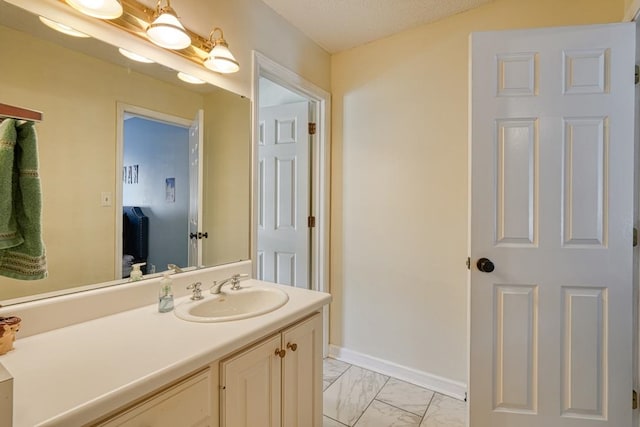 bathroom with vanity and a textured ceiling