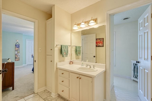 bathroom with vanity and a textured ceiling