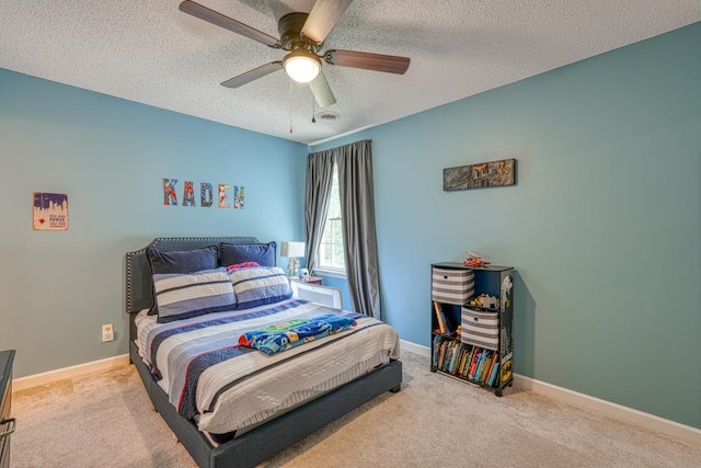 carpeted bedroom with ceiling fan and a textured ceiling