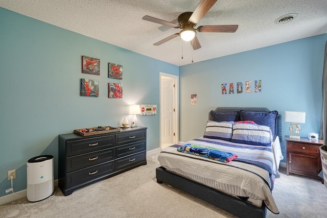 carpeted bedroom with a textured ceiling and ceiling fan