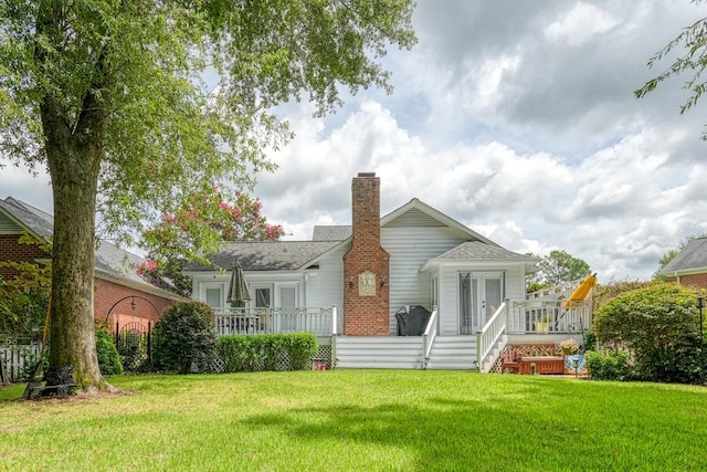 rear view of house with a lawn