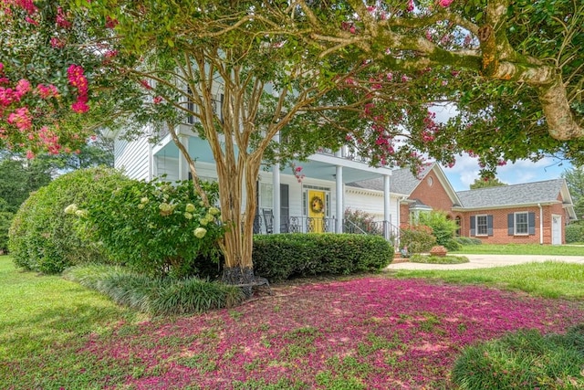 view of front of property with covered porch and a front yard