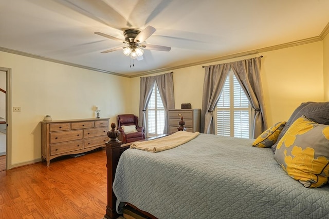 bedroom with hardwood / wood-style flooring, ceiling fan, and ornamental molding