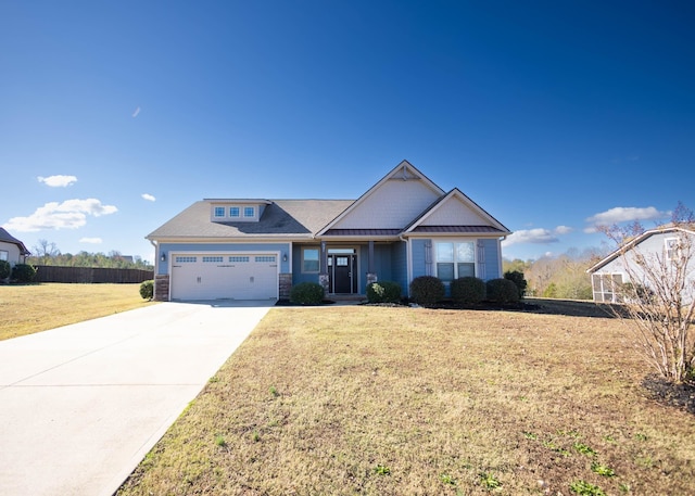 craftsman house with a front lawn and a garage