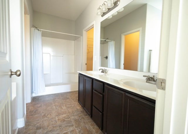 bathroom featuring vanity and curtained shower