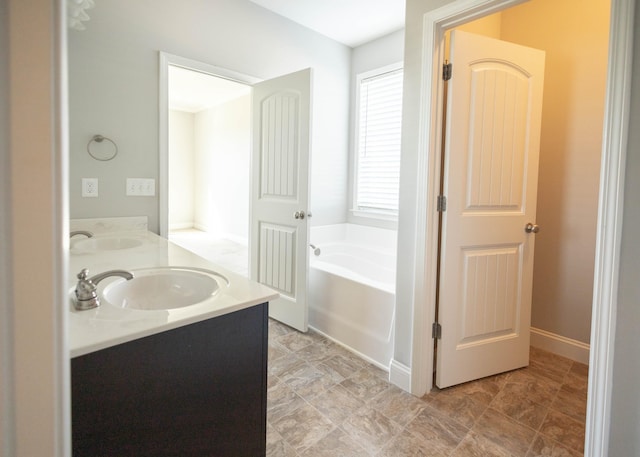 bathroom with vanity and a bath