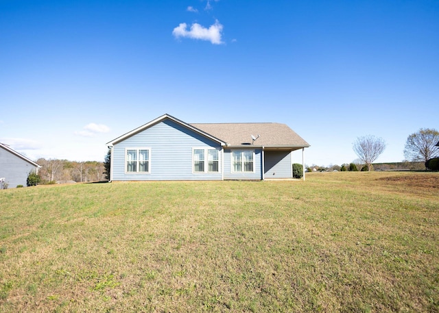 rear view of property with a lawn