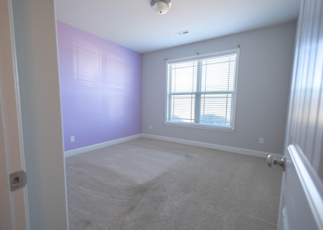 empty room featuring light colored carpet