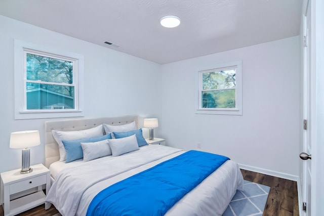 bedroom with dark wood-type flooring