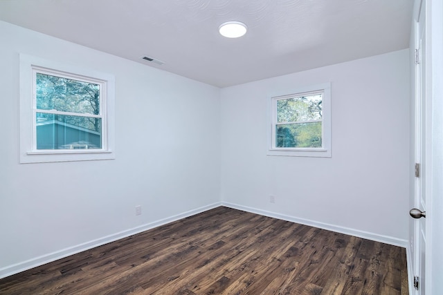 empty room with dark hardwood / wood-style floors