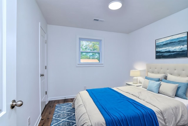 bedroom with dark wood-type flooring