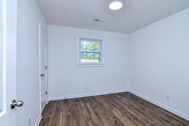 unfurnished room featuring dark hardwood / wood-style flooring