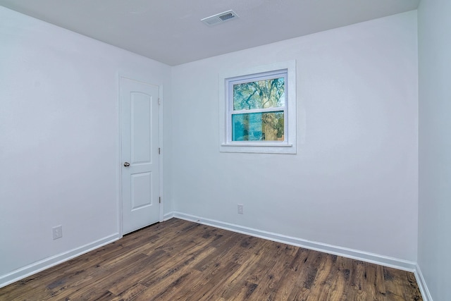 unfurnished room featuring dark wood-type flooring