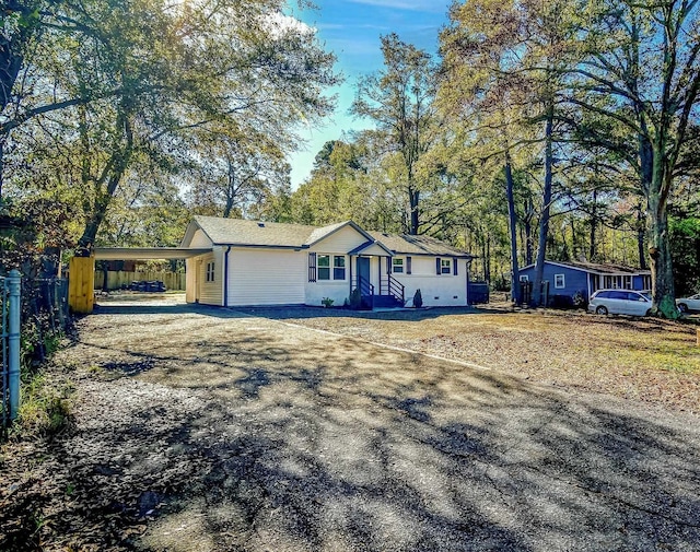 single story home featuring a carport