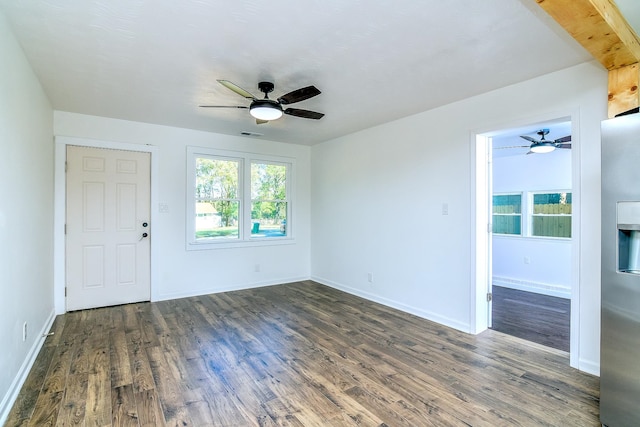 empty room featuring dark hardwood / wood-style flooring and ceiling fan