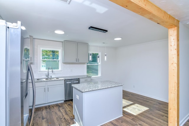 kitchen featuring decorative backsplash, stainless steel appliances, decorative light fixtures, a center island, and dark hardwood / wood-style floors