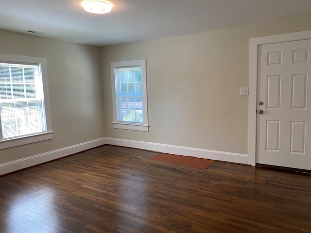 empty room with dark hardwood / wood-style floors