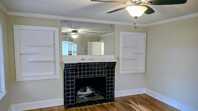 interior space featuring hardwood / wood-style floors, ceiling fan, a fireplace, and a textured ceiling