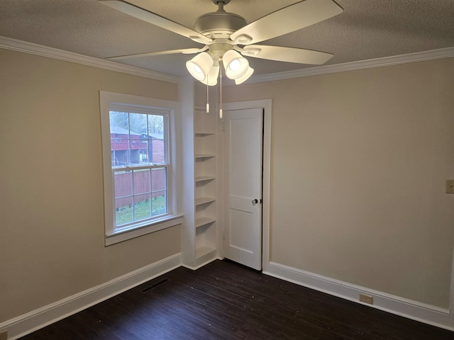 spare room featuring ornamental molding, a textured ceiling, ceiling fan, and dark wood-type flooring