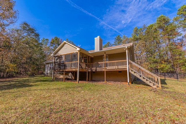 back of house with a lawn, a wooden deck, and a sunroom