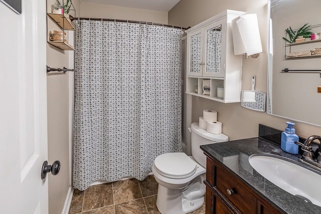 bathroom with tile patterned flooring, vanity, and toilet