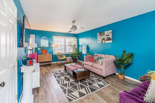 living room with ceiling fan and wood-type flooring