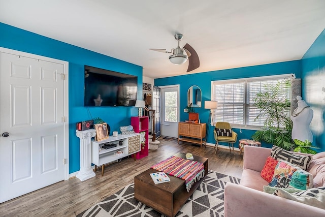 living room with wood-type flooring and ceiling fan