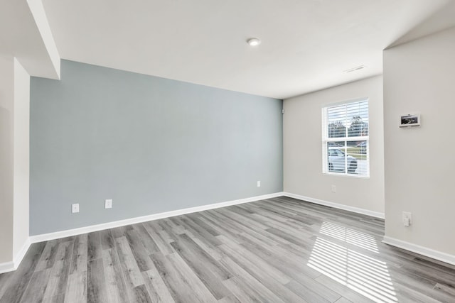 empty room with light hardwood / wood-style flooring