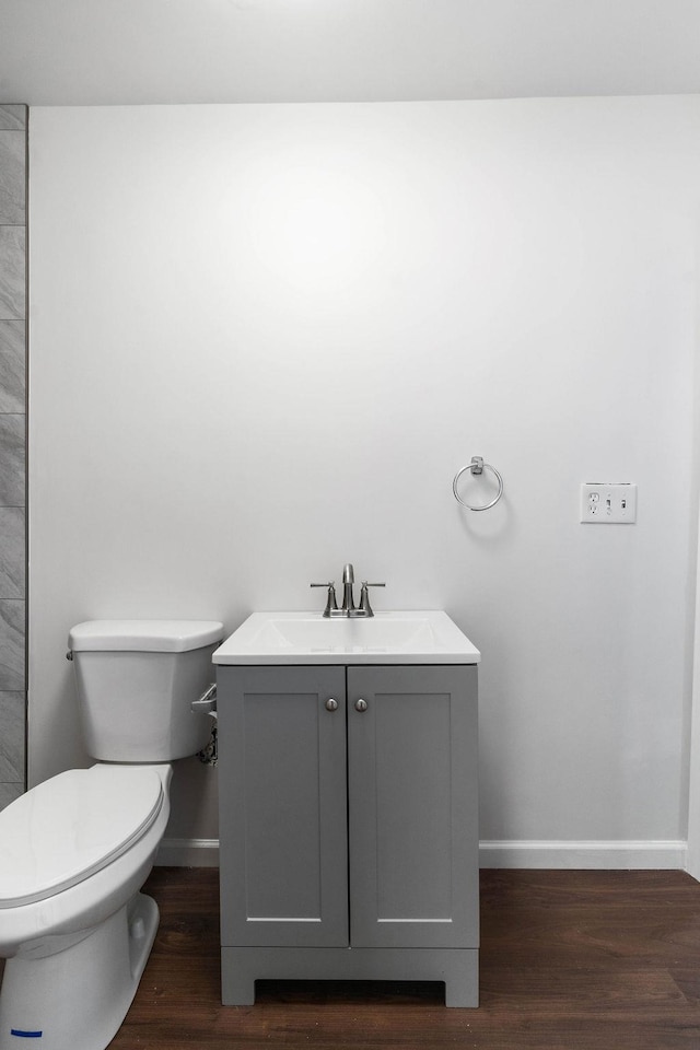 bathroom featuring hardwood / wood-style floors, vanity, and toilet