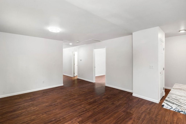 spare room with dark wood-type flooring