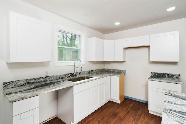 kitchen featuring white cabinets, dark hardwood / wood-style flooring, and sink