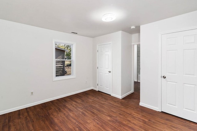 unfurnished bedroom featuring dark wood-type flooring