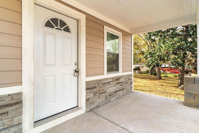 view of exterior entry with covered porch