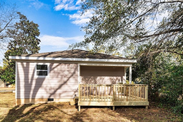 back of house with a wooden deck