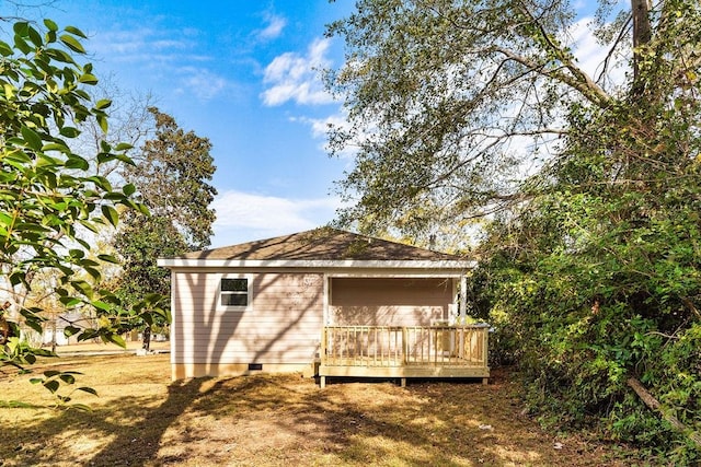 rear view of house featuring a deck