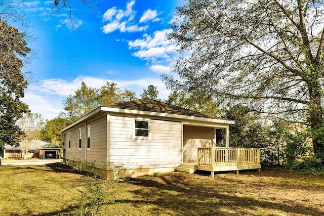 view of front facade with a front lawn and a deck