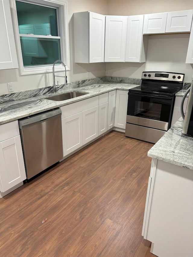 kitchen featuring white cabinets, dark wood-type flooring, and appliances with stainless steel finishes