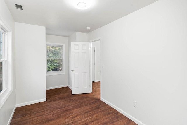 spare room featuring dark hardwood / wood-style flooring