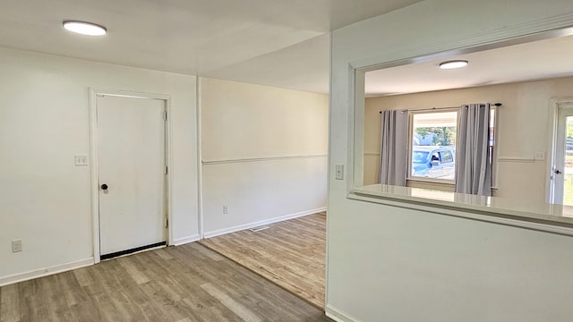 empty room with hardwood / wood-style flooring