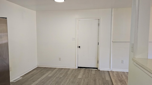 spare room featuring light hardwood / wood-style flooring