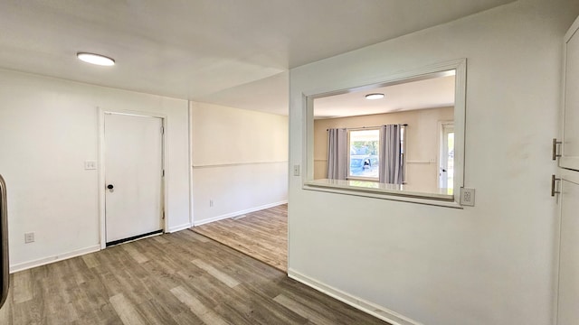 spare room featuring wood-type flooring