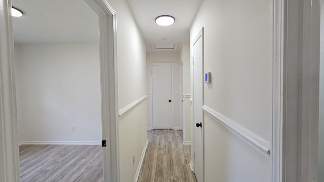 hallway with light hardwood / wood-style flooring