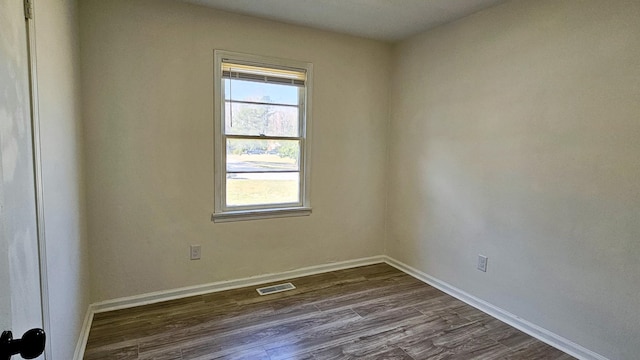 empty room featuring dark hardwood / wood-style flooring