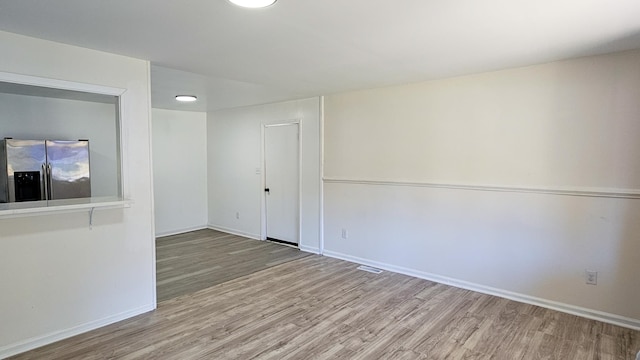 spare room featuring light hardwood / wood-style flooring