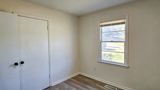 unfurnished bedroom with hardwood / wood-style flooring